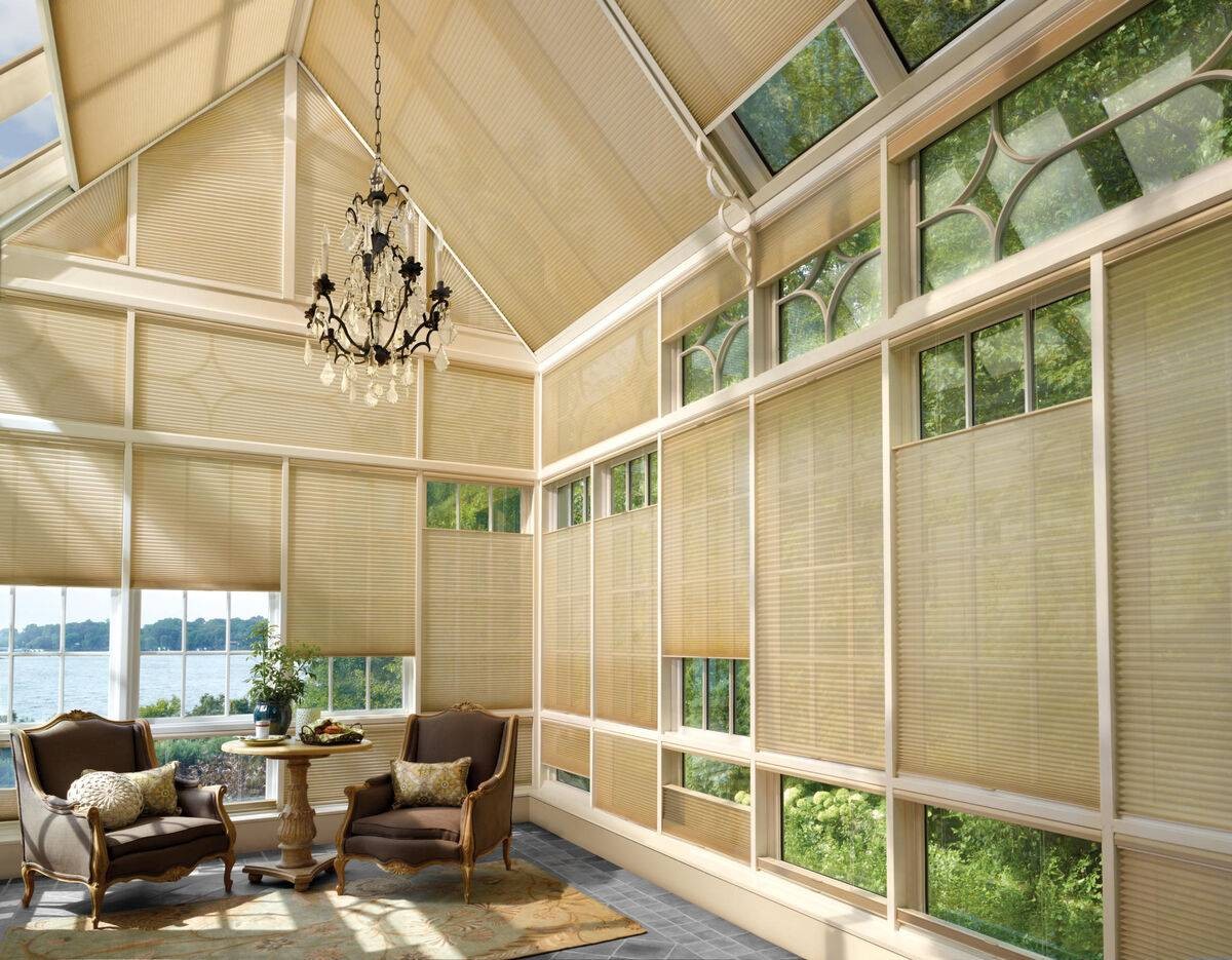 Large sunroom with skylights decorated with Hunter Douglas Duette® Cellular Shades near Rehoboth Beach, DE