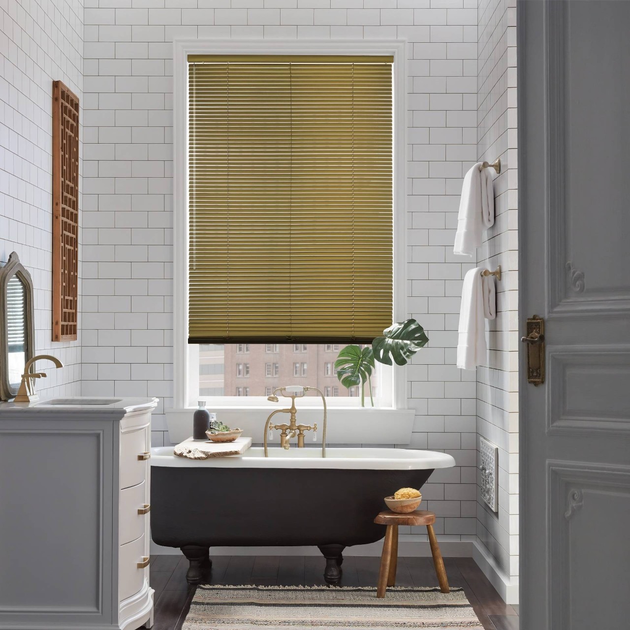 Apartment bathroom with Hunter Douglas Modern Precious Metals® Mini Blinds in the window near Rehoboth Beach, DE