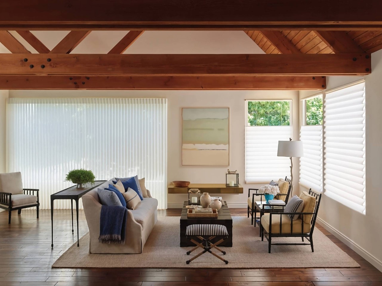 Hunter Douglas shades for sliding glass doors and windows in a spacious living room with exposed ceiling beams at Dreamweaver Interiors & Fabrics near Rehoboth Beach, DE