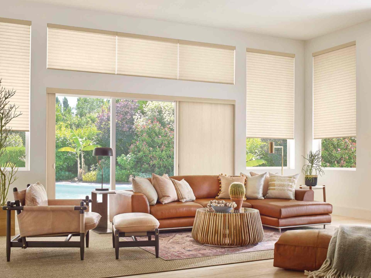Hunter Douglas Sonnette® Roller Shades for sliding glass doors in a stylish living room at Dreamweaver Interiors & Fabrics near Rehoboth Beach, DE